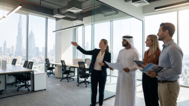 A commercial real estate agent touring an open-plan fitted commercial office space in Dubai with corporate clients overlooking the Downtown skyline.